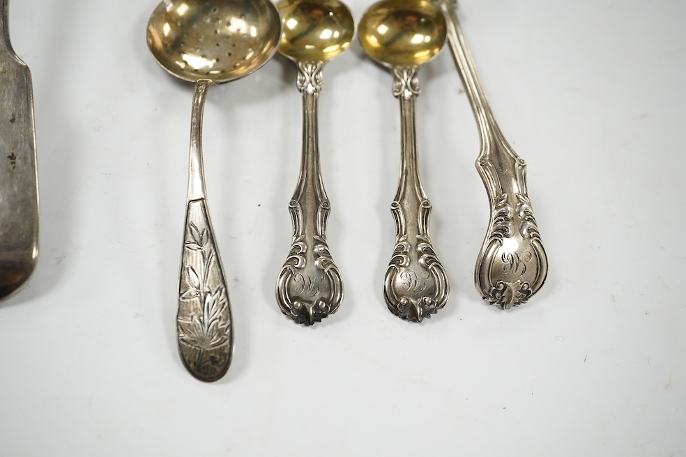 A George IV silver fiddle pattern soup ladle, London, 1827, 32.1cm, together with two sifter spoons (one silver) and a pair of silver mustard ladles. Condition - fair